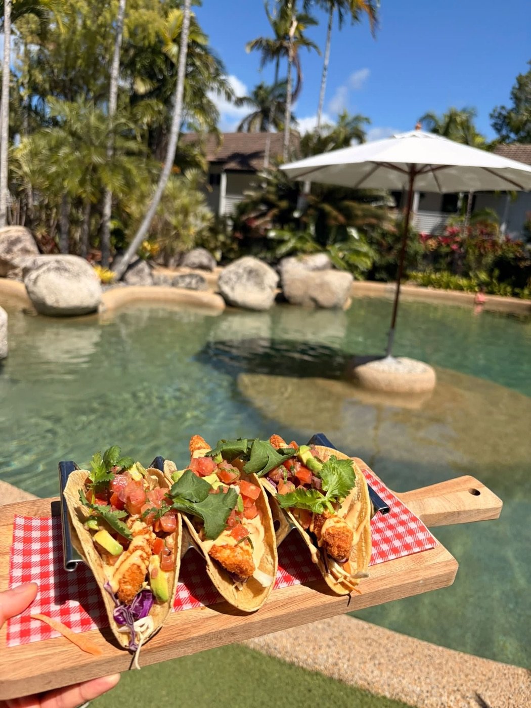Crispy prawn tacos served beside the resort lagoon pool